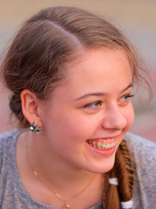 Smiling young girl with straight teeth