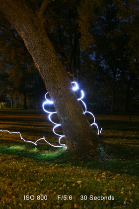 Light painting above a tree stump