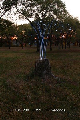 Light painting above a tree stump