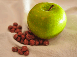 an apple and hazelnuts