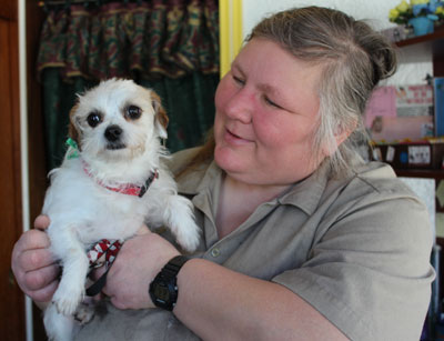 Dee from Dee's Dog Salon with a small older dog