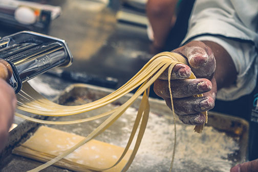 Picture of the Gugliatto's staff member preparing the homemade noodles.